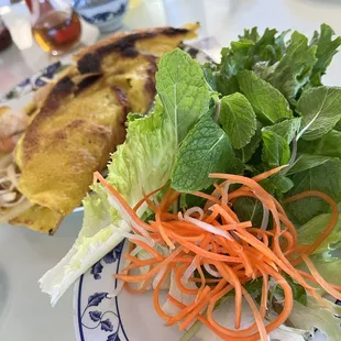 The crispy crepe served with lettuce leaves, mint, shredded carrots &amp; daikon.