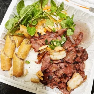 a plate of meat, rice, and vegetables