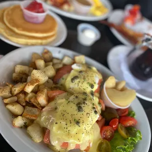 Smoked salmon Benedict  Peasant potatoes  Field tomatoes  and braised granny apple smith Dollar size pancakes