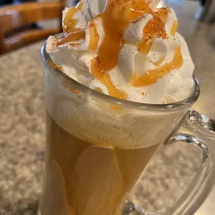 a cup of coffee with whipped cream and caramel