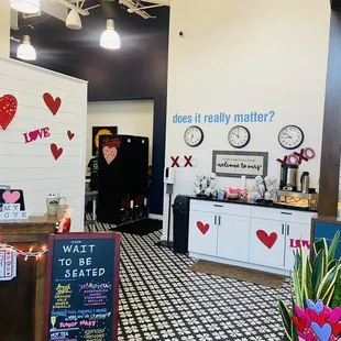 a woman standing in a room with a checkered floor