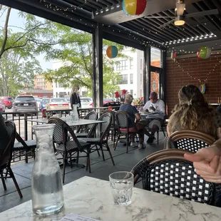 people sitting at tables in a restaurant