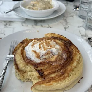 Cinnamon Roll pancakes (omg!!!) and biscuits and gravy in the background (also perfection)