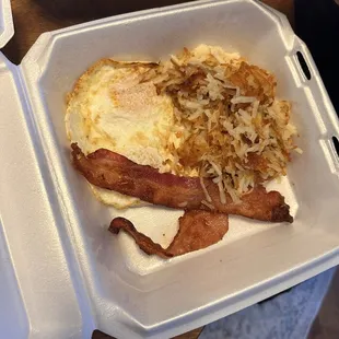 Side of bacon, over medium eggs. Hash brown potatoes