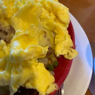 a plate of food with eggs and sausage