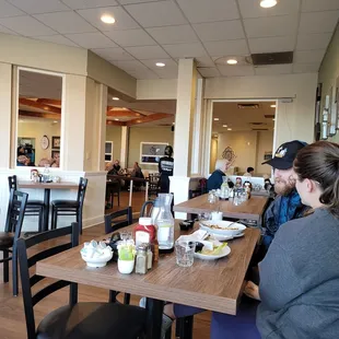 people sitting at tables in a restaurant