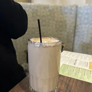 a drink in a glass on a table