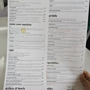 a person holding a menu