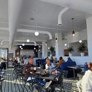 people sitting at tables in a restaurant