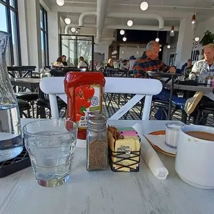 a view of a table with a cup of coffee and a blender on it