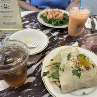 Shrimp remoulade salad &amp; a frozen peach Bellini in the back and a spinach and curry chicken salad crepe &amp; an unsweet iced tea up front.