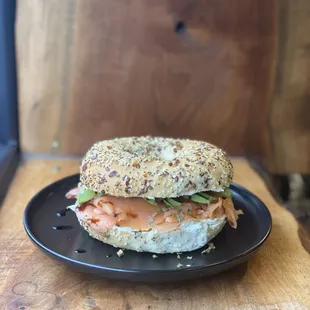 a bagel sandwich on a black plate