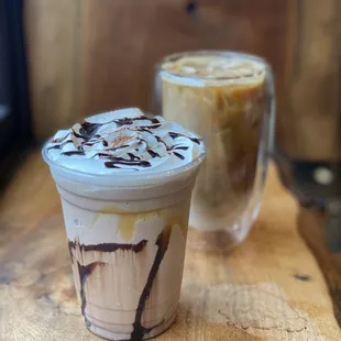 two iced coffees on a wooden table