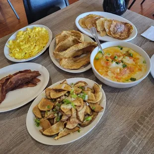 Shrimp and Grits, Fried Catfish, Scrambled Eggs, Corn Pancakes, Bacon, Potatoes with Onions and Bell Pepper