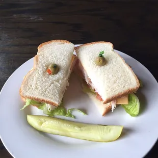 a sandwich and pickle on a plate