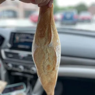 a person holding a baguet