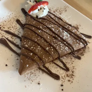 Chocolate crepe with Bavarian crème, sliced strawberries and bananas topped with Nutella. Yum!!