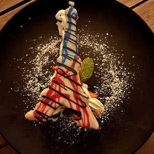 la tour eiffel: flakey puff pastry, vanilla crème diplomate, fresh berries, white chocolate glaze = $14