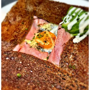 a plate of food with a fried egg on top