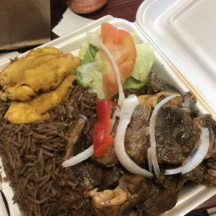 a tray of rice, meat, and vegetables