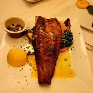 a plate of fish and vegetables