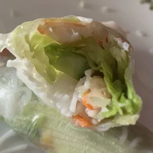 Interior of fresh spring roll with shrimp. Hardly any rice noodles, lots of lettuce and cucumber.