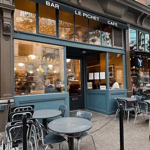 tables and chairs outside a cafe