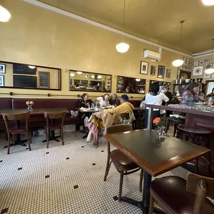 people sitting at tables in a restaurant