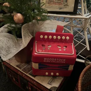 a red accordion and christmas tree