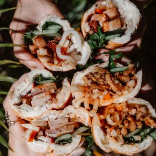 three different types of banh mi:
 Top: roast pork
 Left: saigon special
 Right: lemongrass chicken