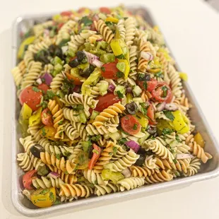 a tray of pasta salad on a table
