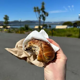 a person holding a piece of bread