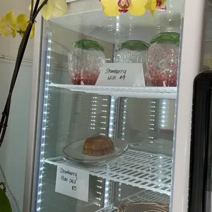 a cake and flowers in a refrigerator