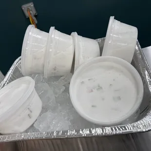 a container of soup and containers of ice