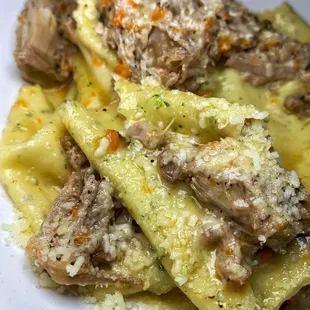 a plate of pasta with meat and cheese