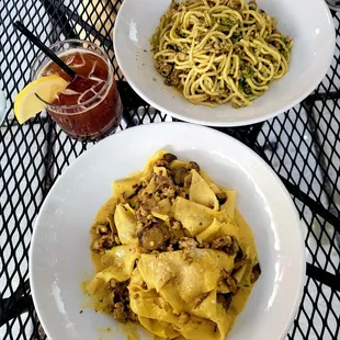 two plates of pasta on a table