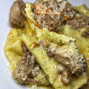 a plate of pasta with meat and cheese