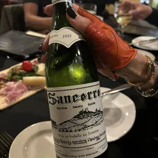 a person holding a bottle of wine