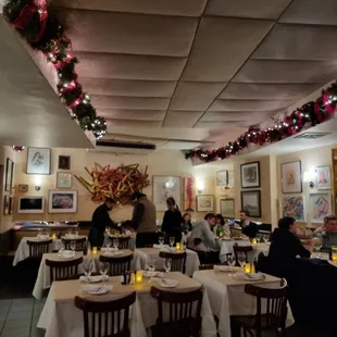people sitting at tables in a restaurant