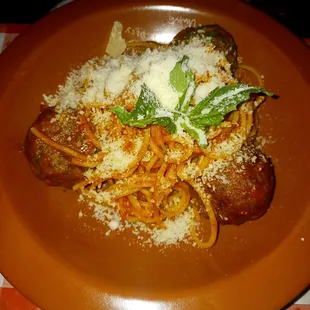 Spaghetti and meatball with parmesan cheese.