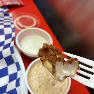 Dipping those tenders in some comeback sauce and garlic sauce!