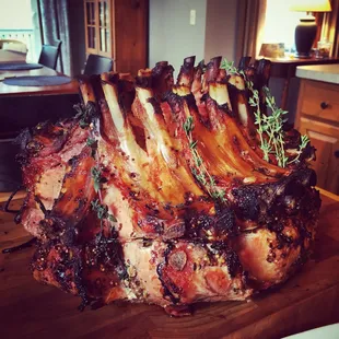 Crown roast of pork served with shallots and apple