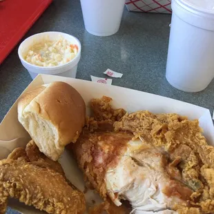 a plate of fried chicken with a side of coleslaw