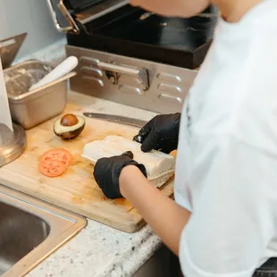 Barista creating fresh sandwich