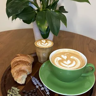 a cup of coffee and a croissant