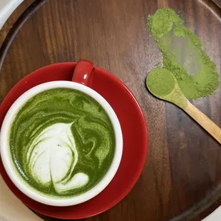 a cup of matcha and a spoon
