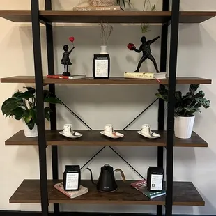a shelf with books and plants