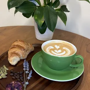 a cup of coffee and a croissant