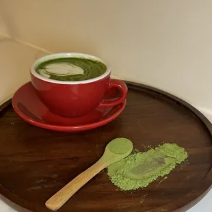 a cup of matcha and a spoon