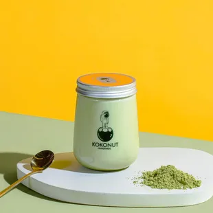  jar of matcha powder and a spoon